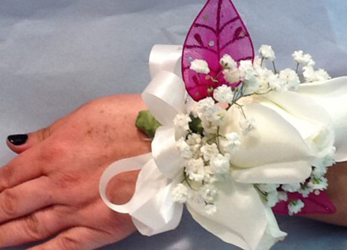 A person holding onto some flowers and a ring