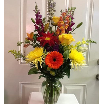 A vase filled with flowers on top of a table.