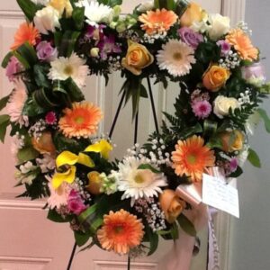 A heart shaped wreath of flowers on display.