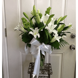 A vase of flowers on the door way.