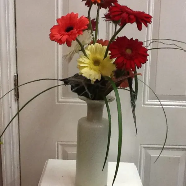 A vase with flowers on top of a table.