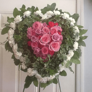 A heart shaped wreath of roses on the door.