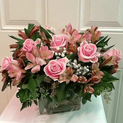 A bouquet of pink roses and other flowers.