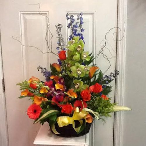 A basket of flowers on the door way.